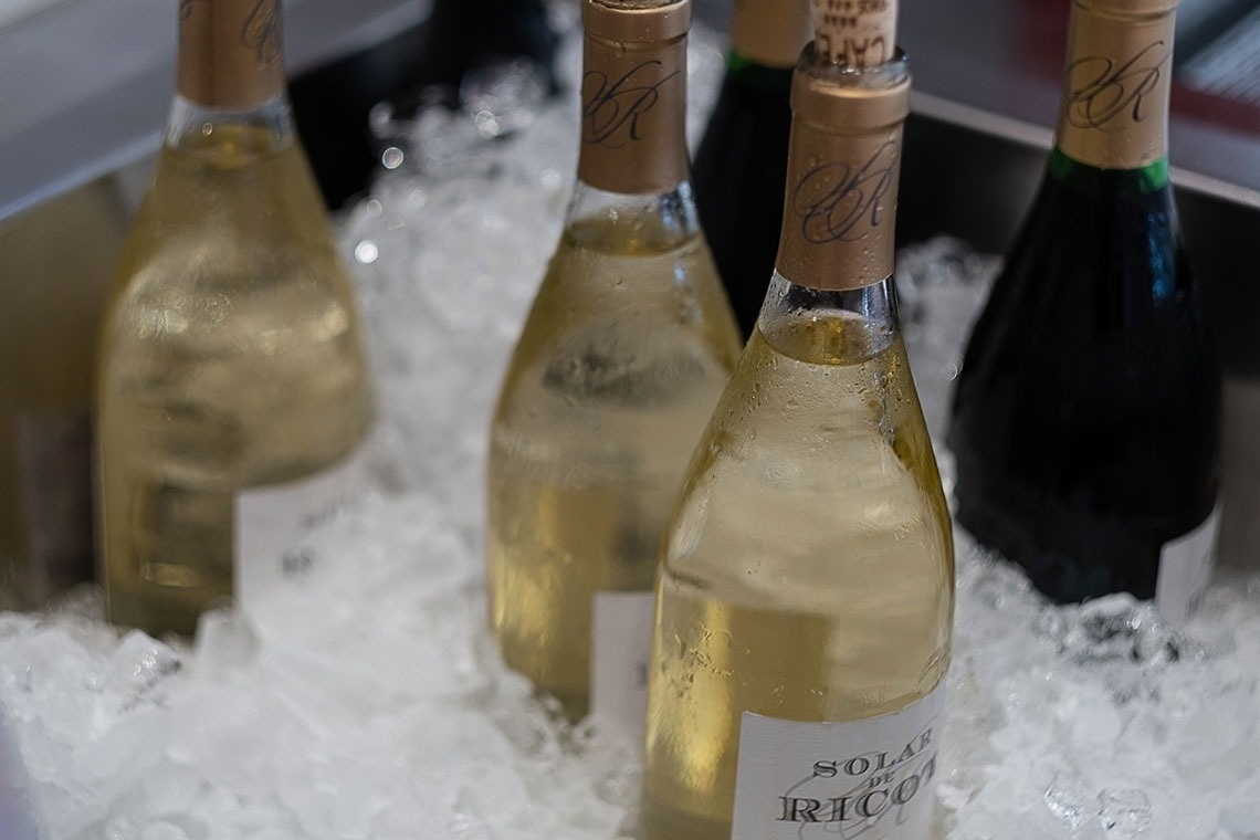 a bottle of sola de rico sits in ice