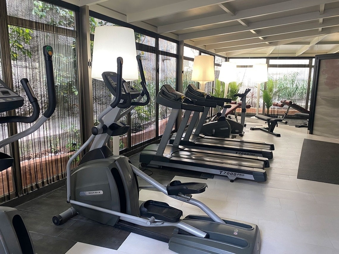 matrix treadmills and ellipticals are lined up in a gym