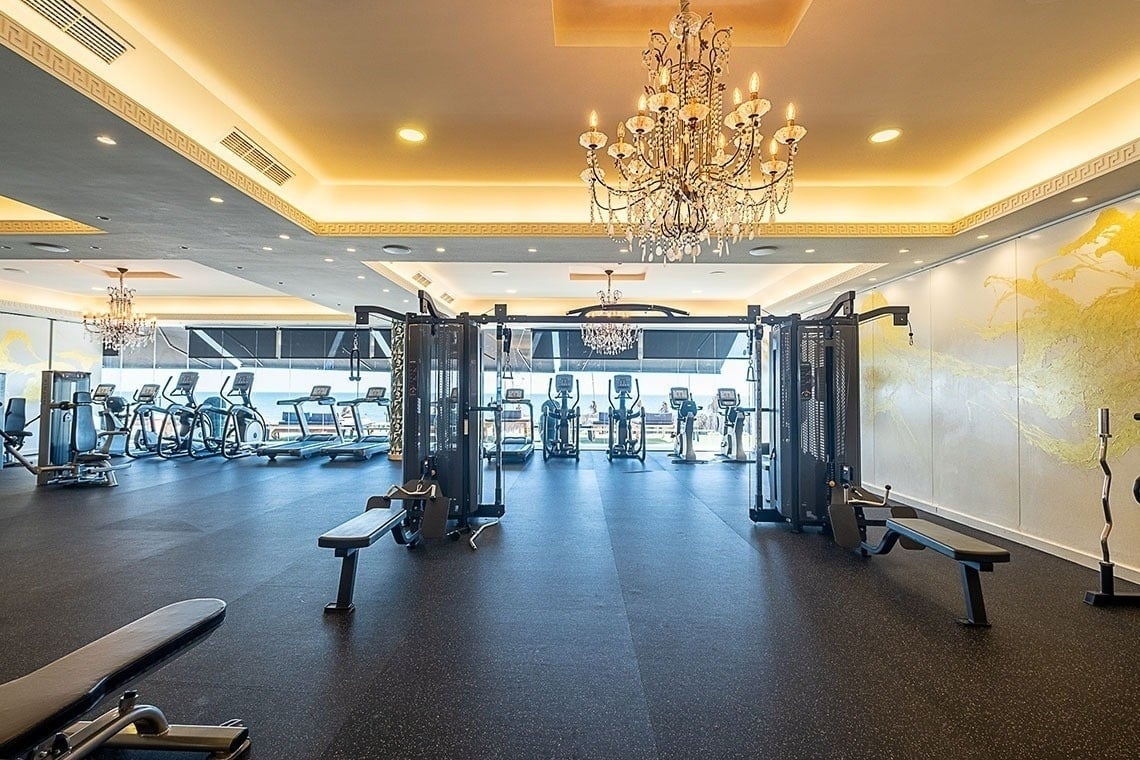 a large gym with a chandelier hanging from the ceiling