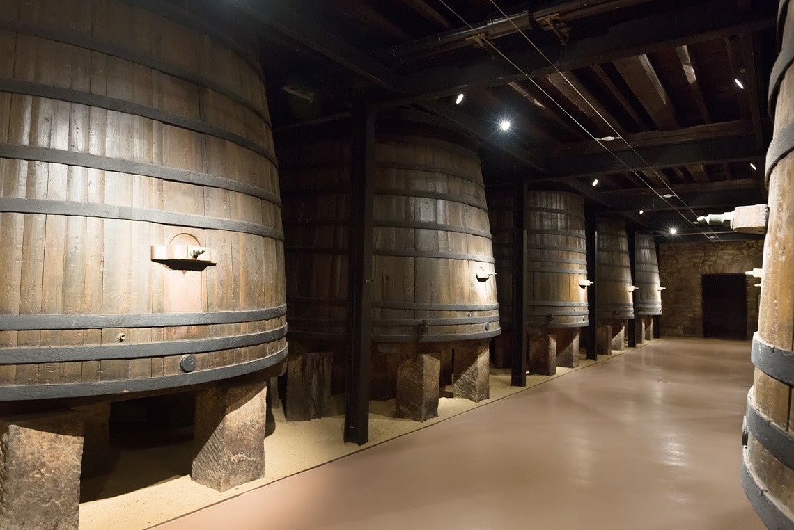 a row of wooden barrels in a dark room