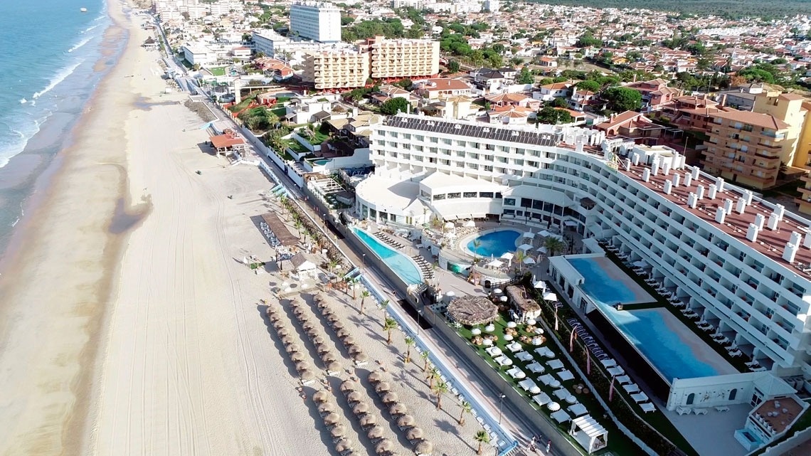 an aerial view of a beach resort with a swimming pool