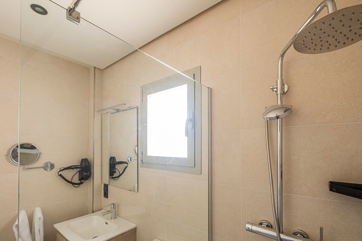 a bathroom with a sink and a shower head
