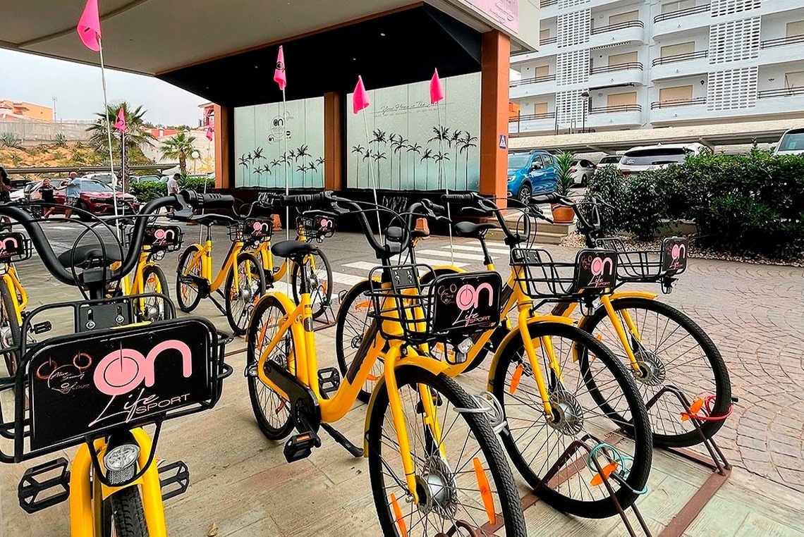 uma fileira de bicicletas amarelas com a palavra on ao lado