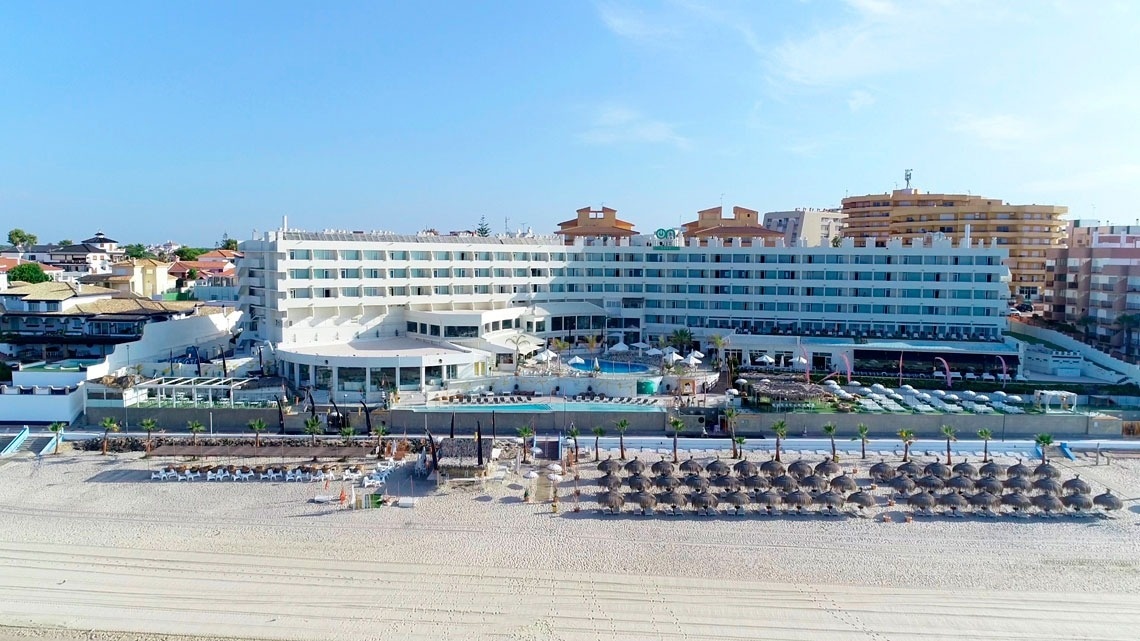 an aerial view of a hotel on the beach