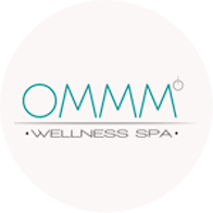 das logo für ommm wellness spa ist in einem weißen kreis .