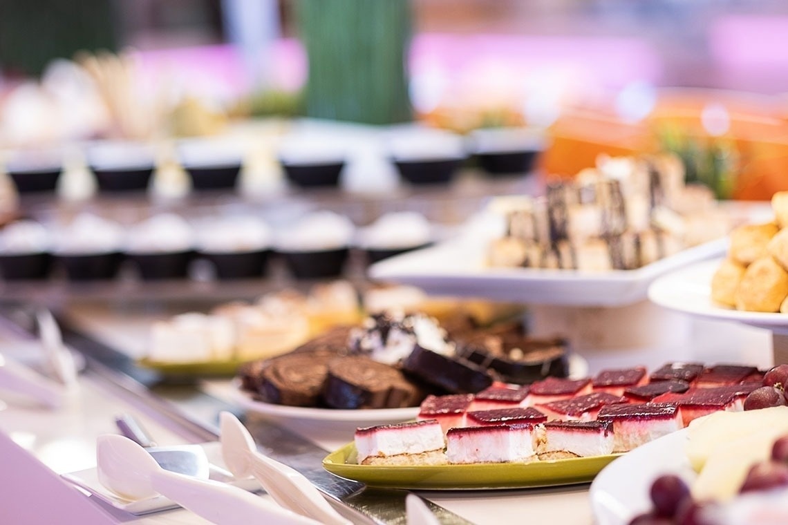 a variety of desserts are on display at a buffet