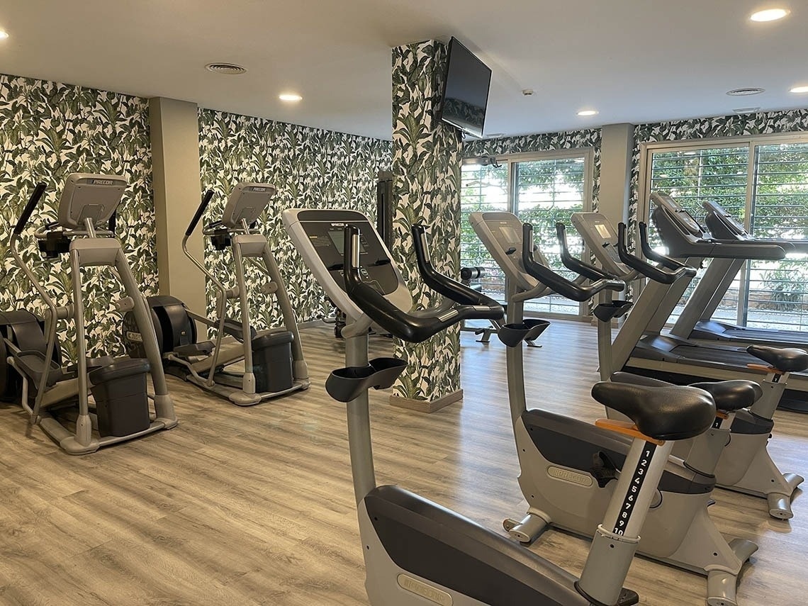 a gym filled with exercise bikes and treadmills