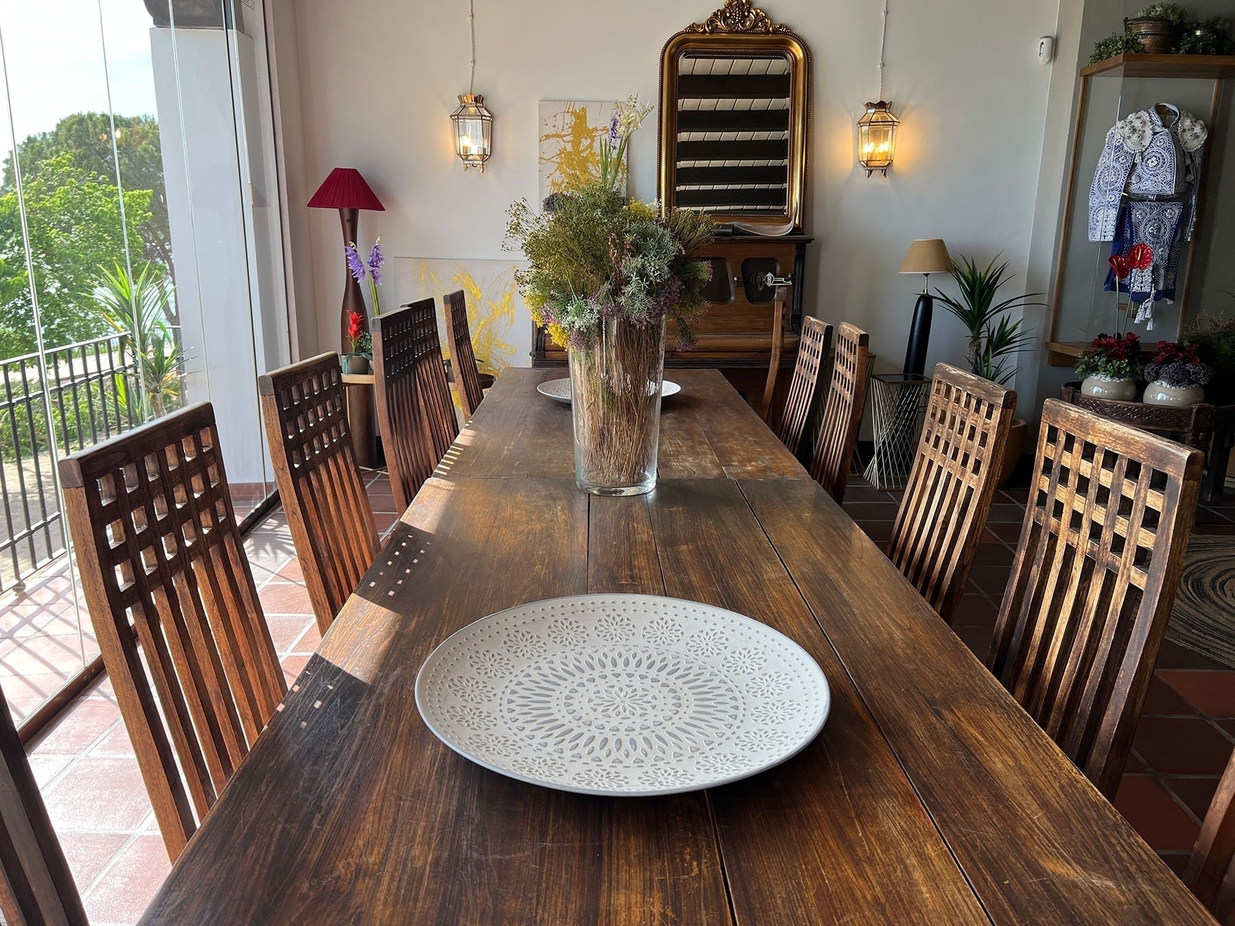 a long wooden table with a white plate on it