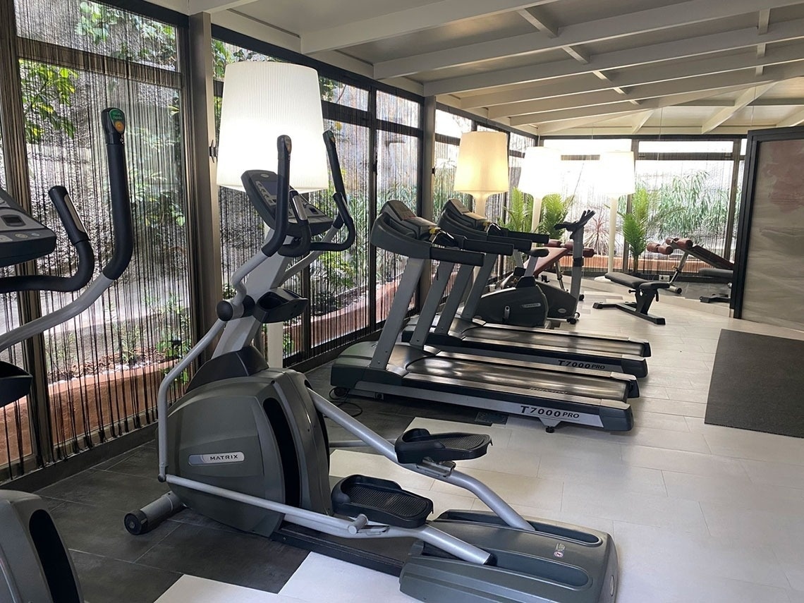 a matrix treadmill is in a gym with other treadmills