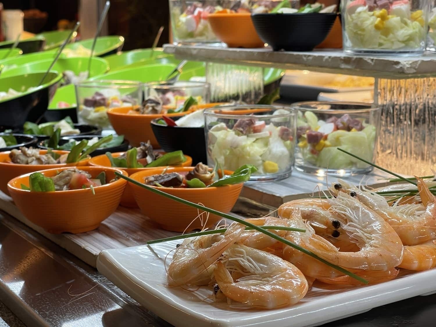 a plate of shrimp sits on a buffet table