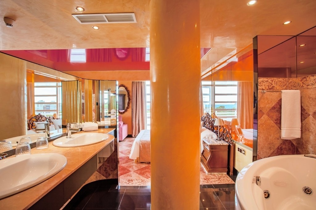 a bathroom with two sinks and a jacuzzi tub