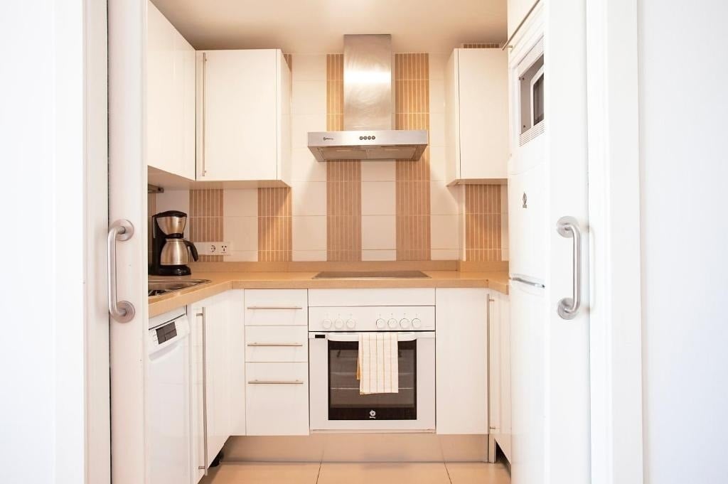 a kitchen with a stainless steel hood that says 0000