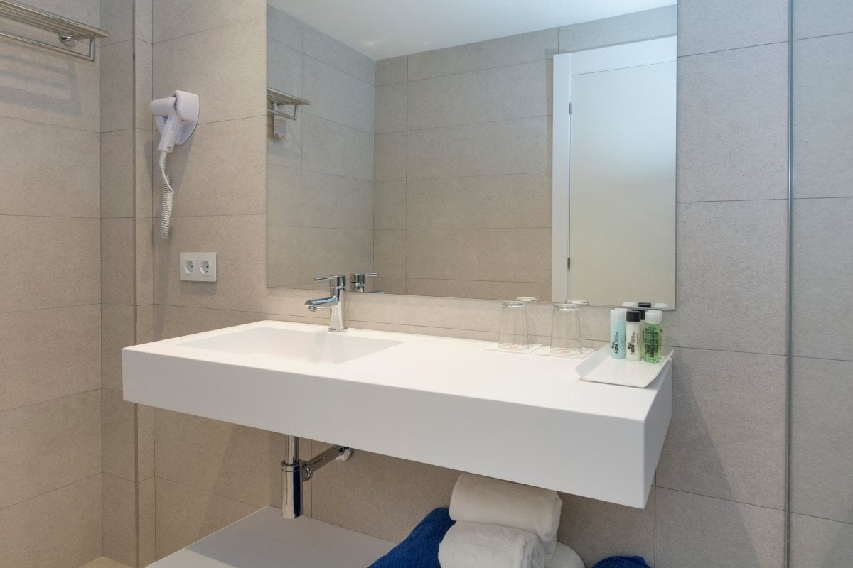 a bathroom with a white sink and a mirror
