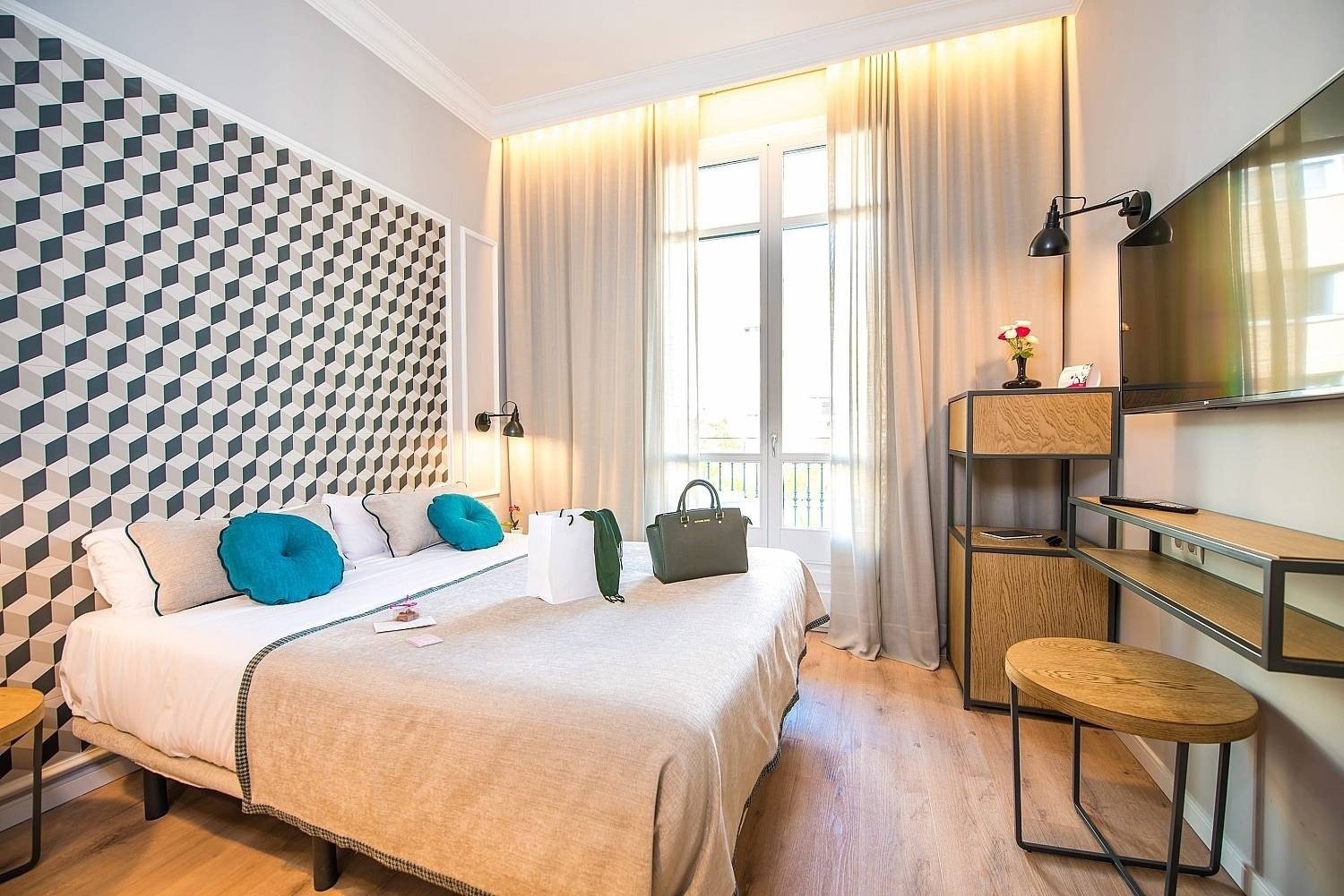 Detail of a room with a double bed at the Hotel Boutique Mosaic by Ona Hotels, in Barcelona