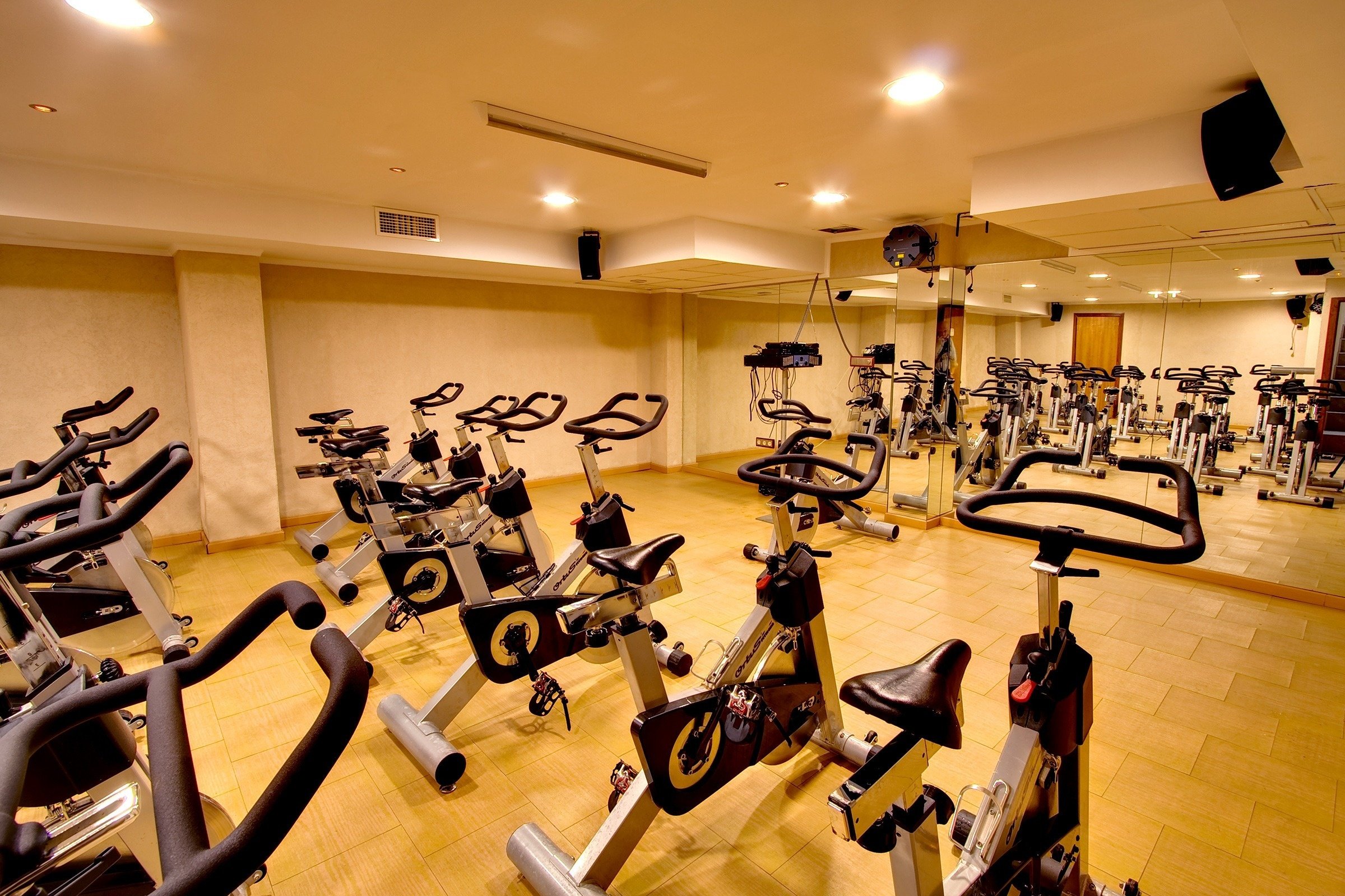 a row of exercise bikes in a gym with the letter q on them