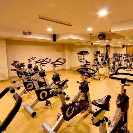 a row of exercise bikes in a gym with the letter q on them