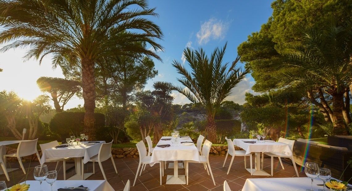 Terrace with tables of the Ona Cala Pi hotel, in Majorca