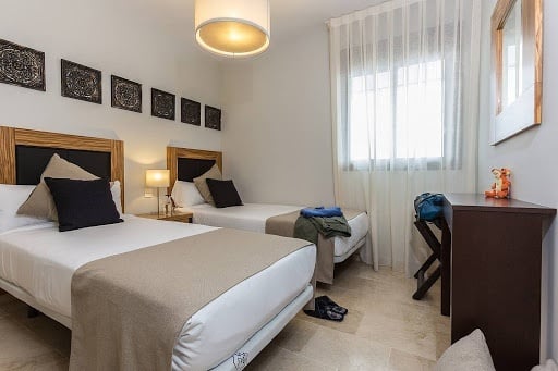 Bedroom with two double beds in the Ona Valle Romano Golf - Resort hotel apartment