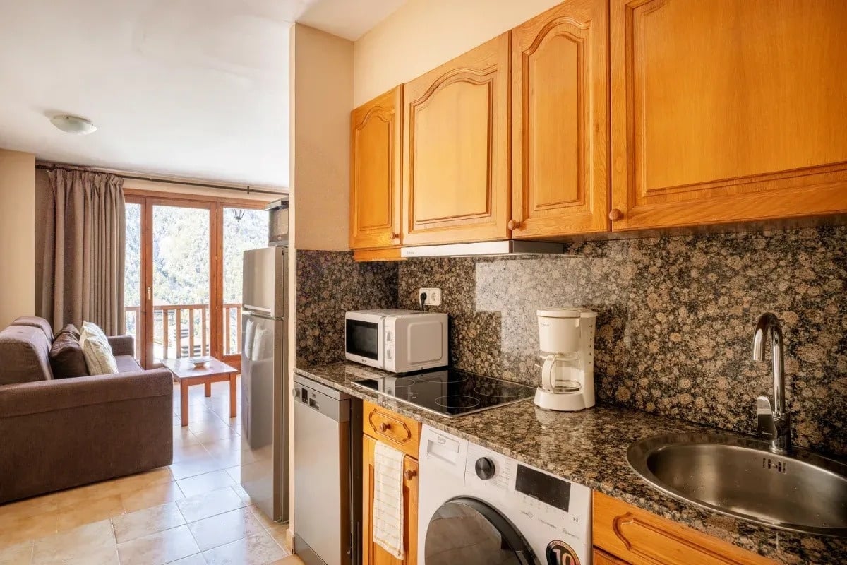 a kitchen with a washer and dryer and a coffee maker