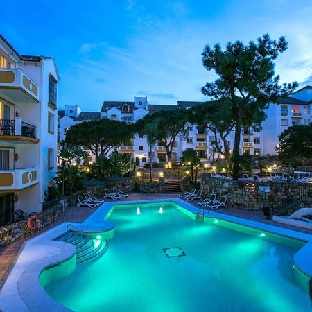 Outdoor pool at night at the Hotel Ona Alanda Club Marbella