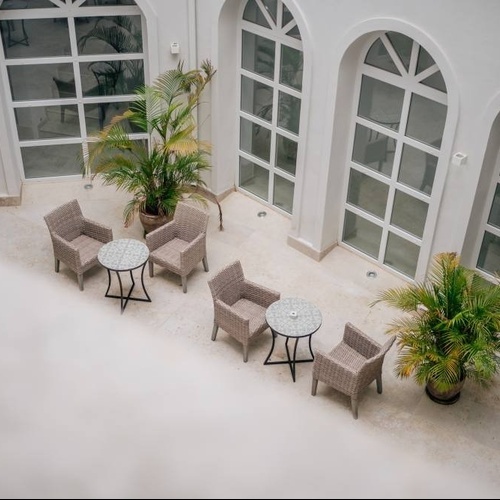 a courtyard with tables and chairs and a sign that says exit