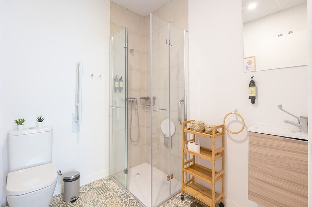 a bathroom with a toilet and a shower stall