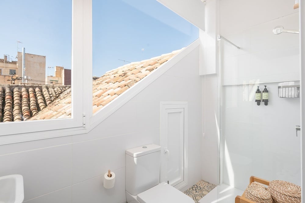 a bathroom with a view of a roof and a toilet