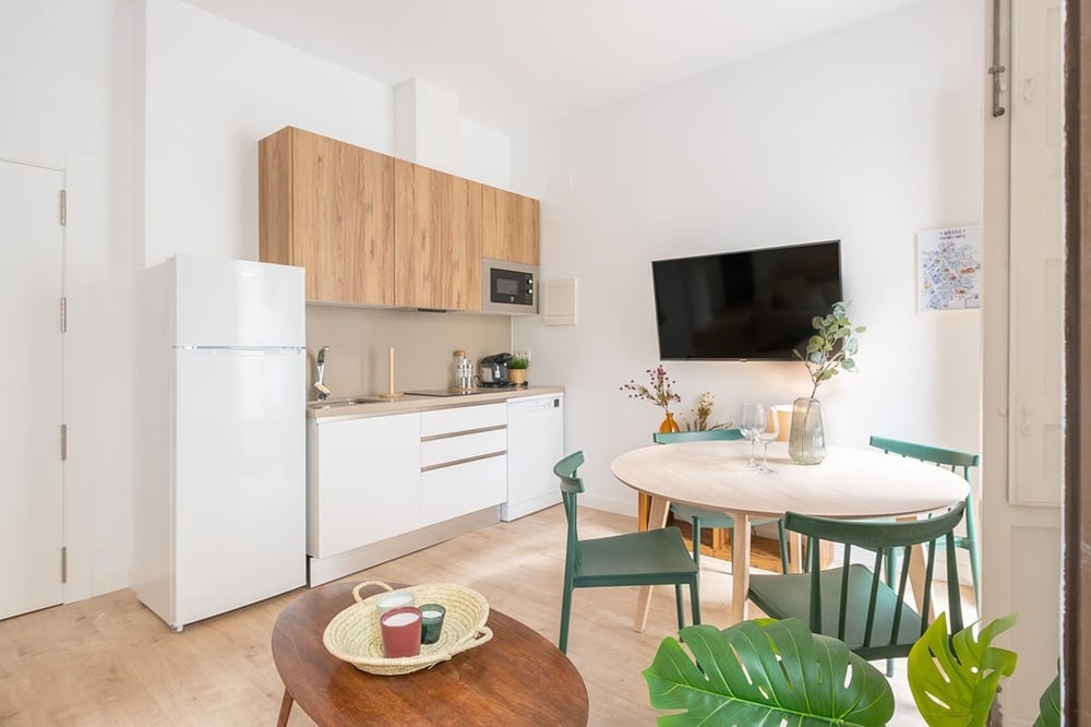 a kitchen with a table and chairs and a tv