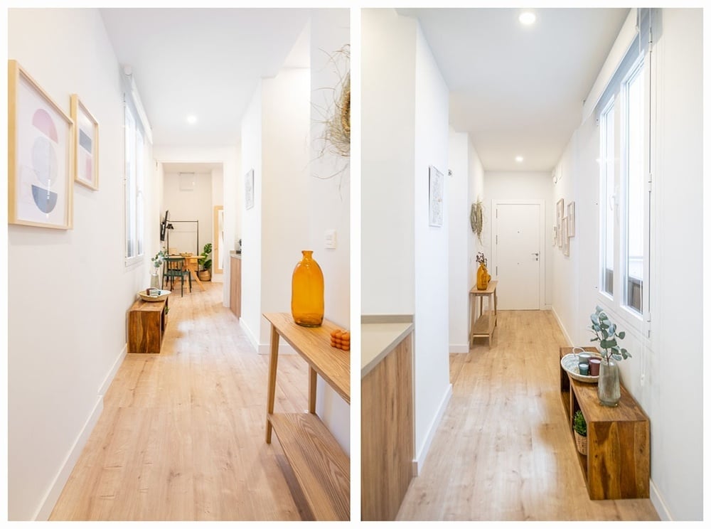 a hallway with a wooden table and vases on it