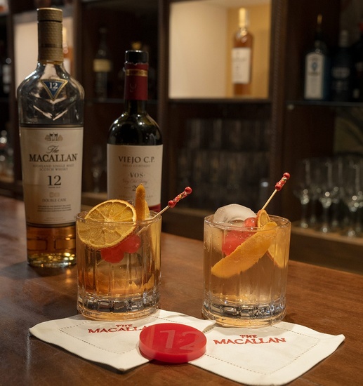 una botella de macallan está al fondo de una mesa de madera