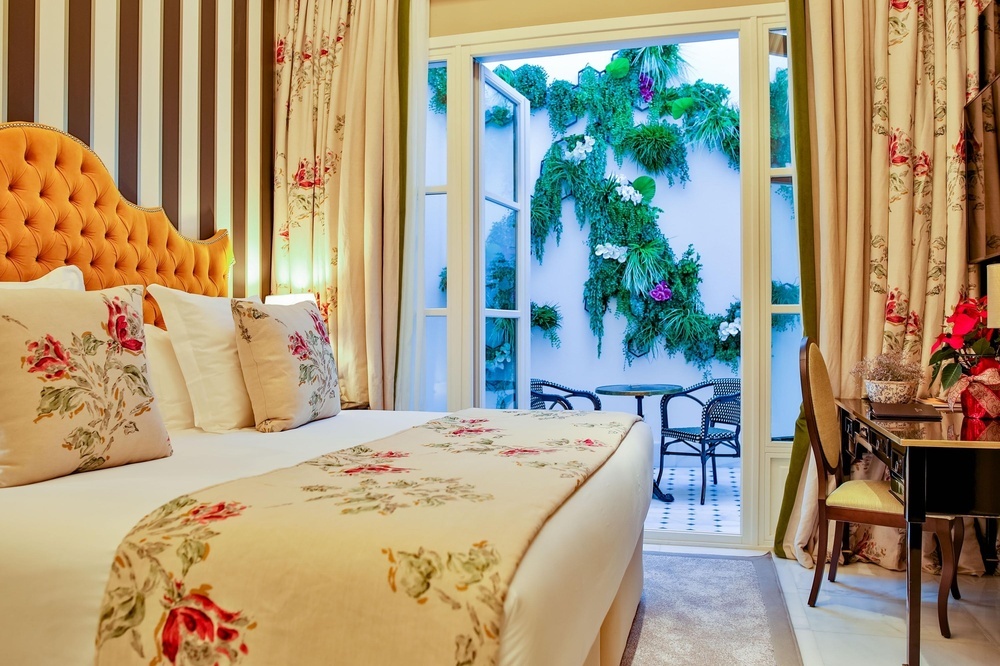 a bedroom with a large bed and a floral blanket