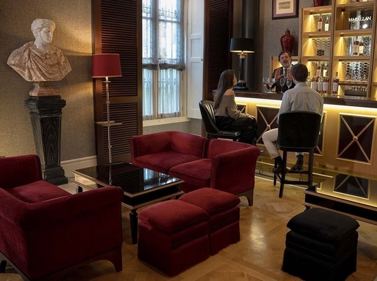 un hombre y una mujer están sentados en un bar de macallan