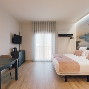 a hotel room with a bed and a table