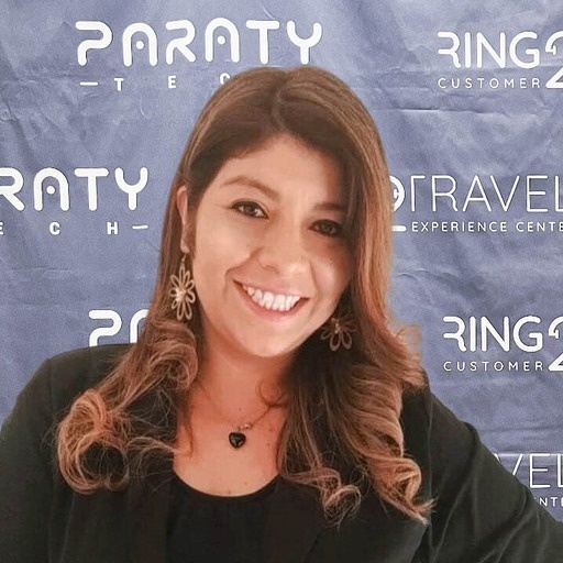 a woman is smiling in front of a paraty banner