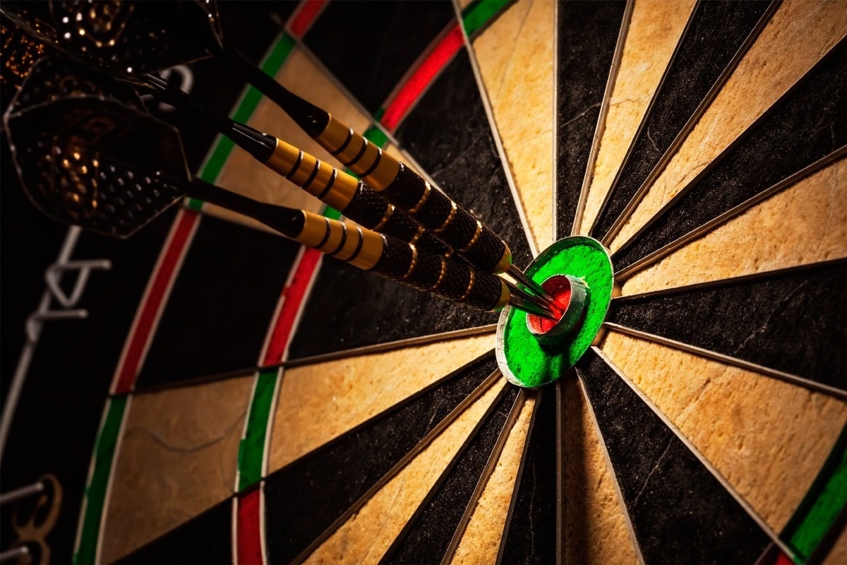 a close up of a dart board with a dart in the center