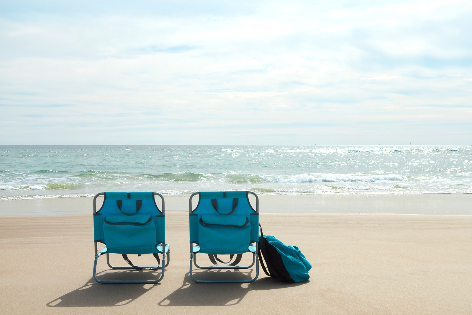 Woman sunbathing on beach lounge chair, REEM: Park Central South Beach Hotel.
