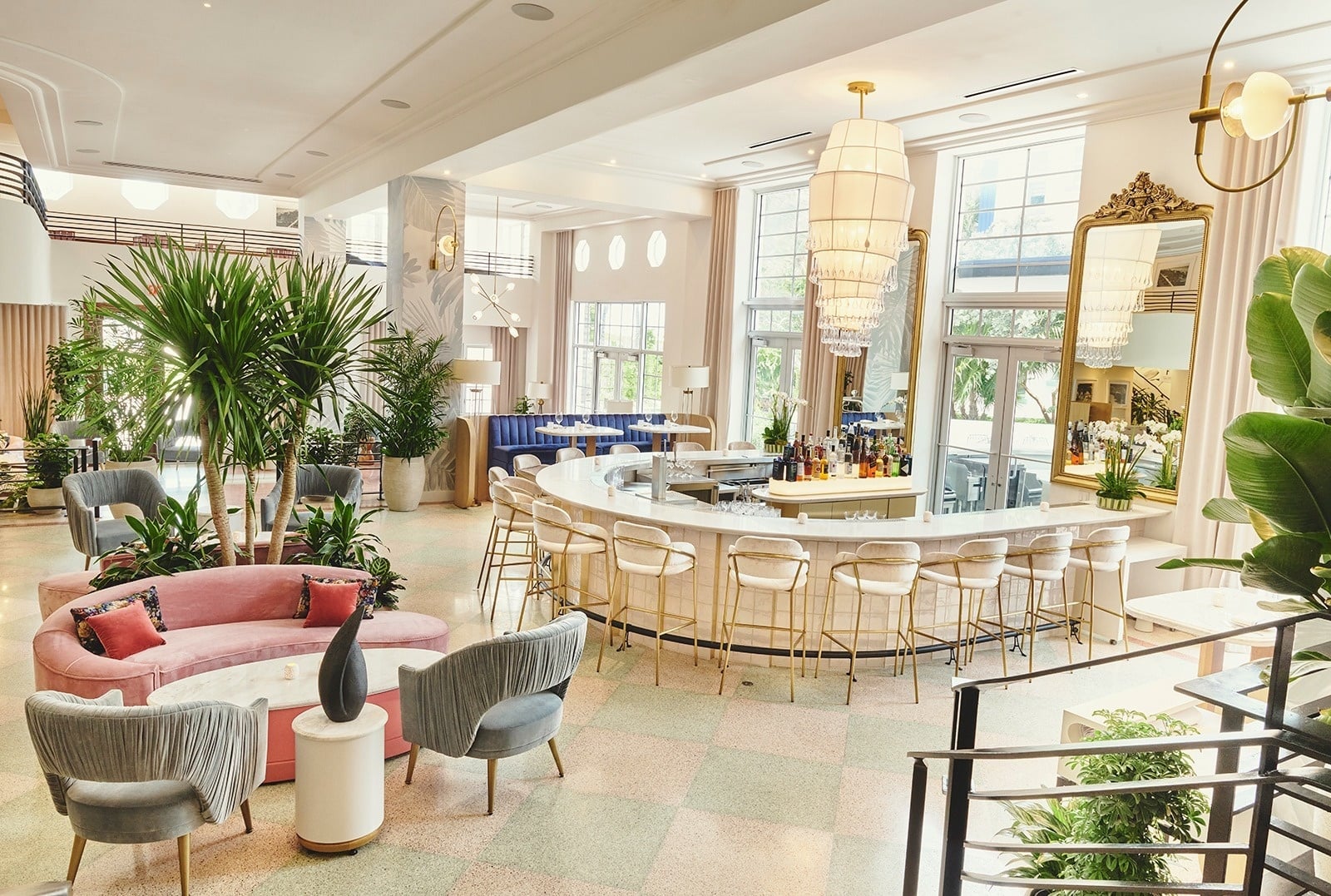 a woman sits on a pier looking at the ocean
