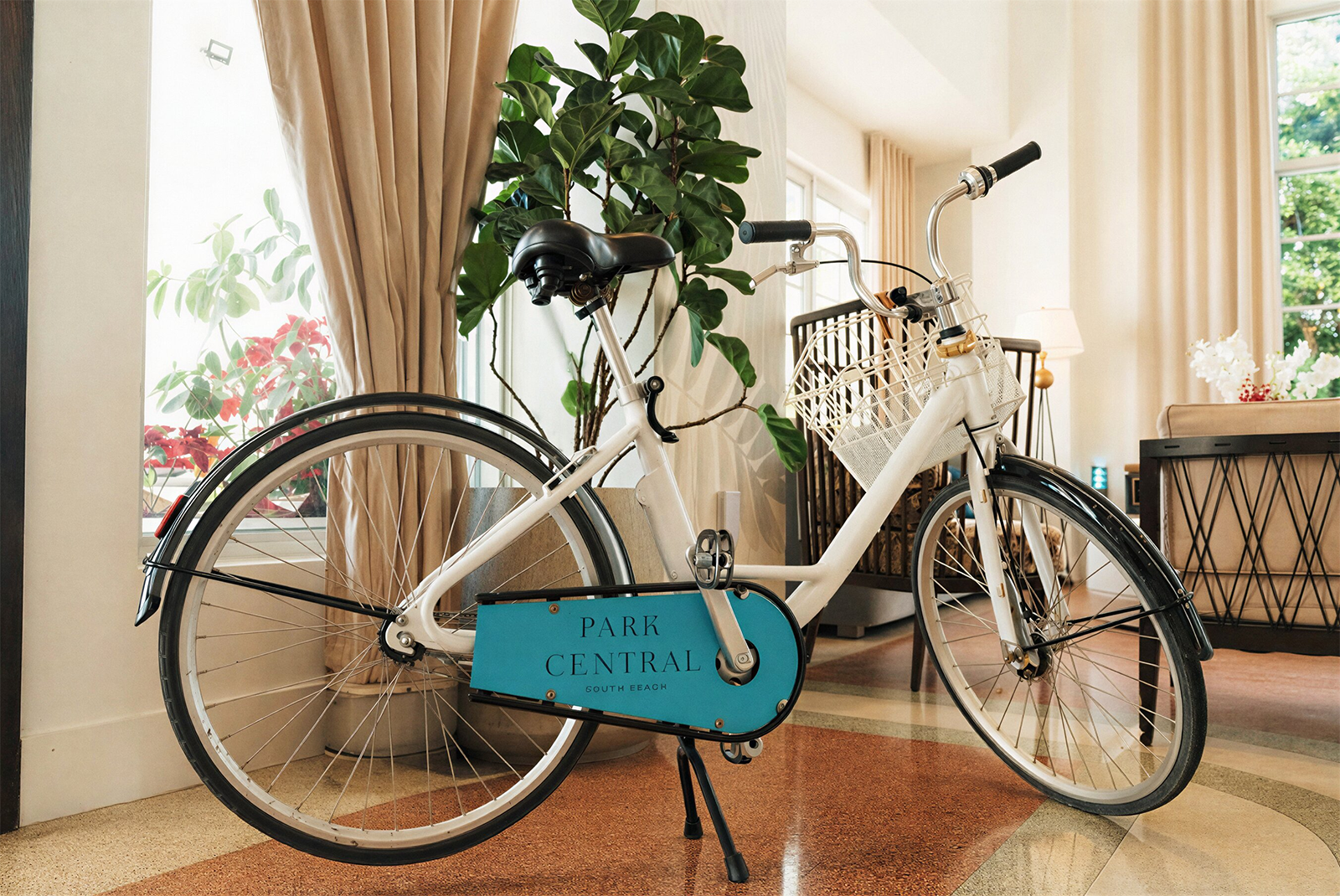White bicycle with REEM: Park Central South Beach Hotel logo for exploring the area.