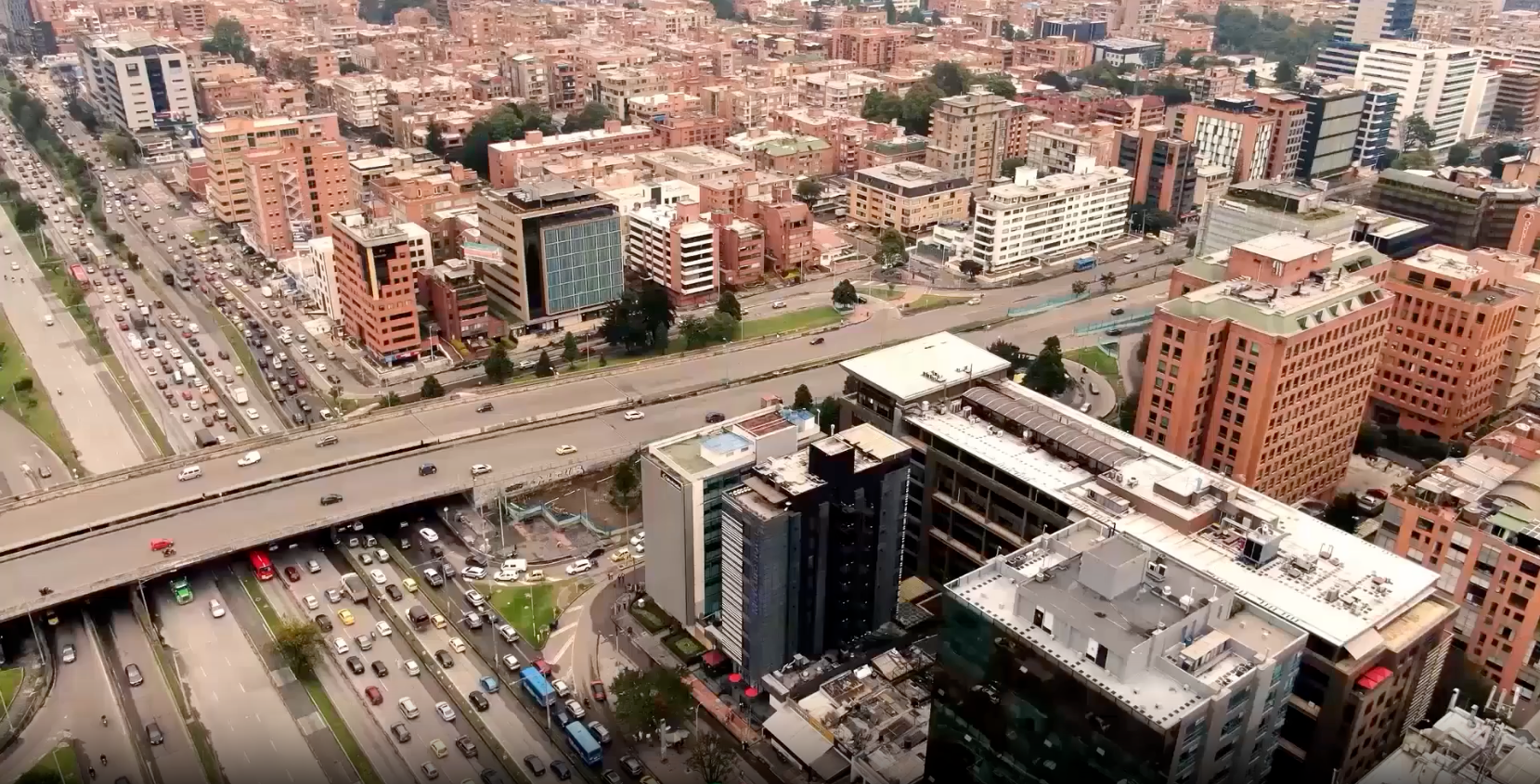 an aerial view of a busy city with a building that says ' santander ' on it