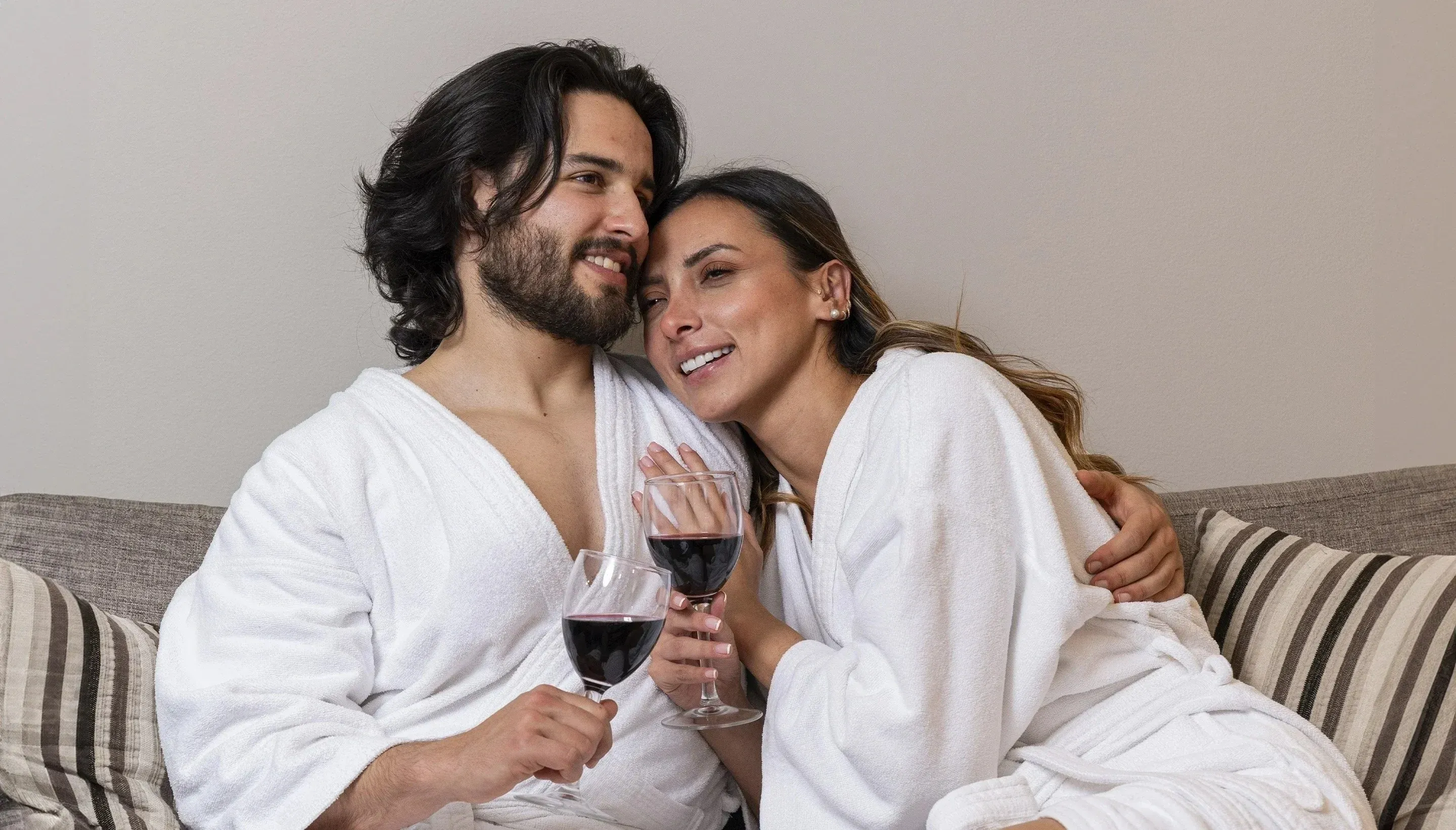 Couple enjoying wine in plush robes 101 Park House Hotel.