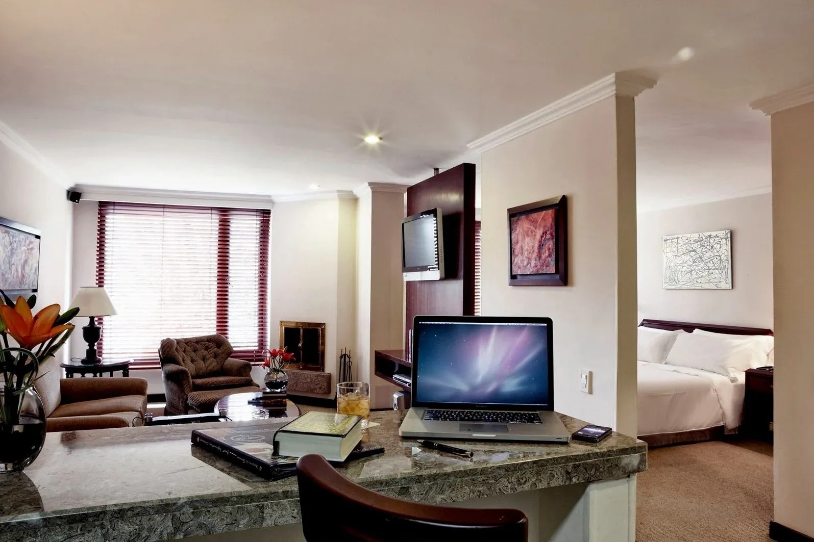 a laptop is sitting on a counter in a hotel room