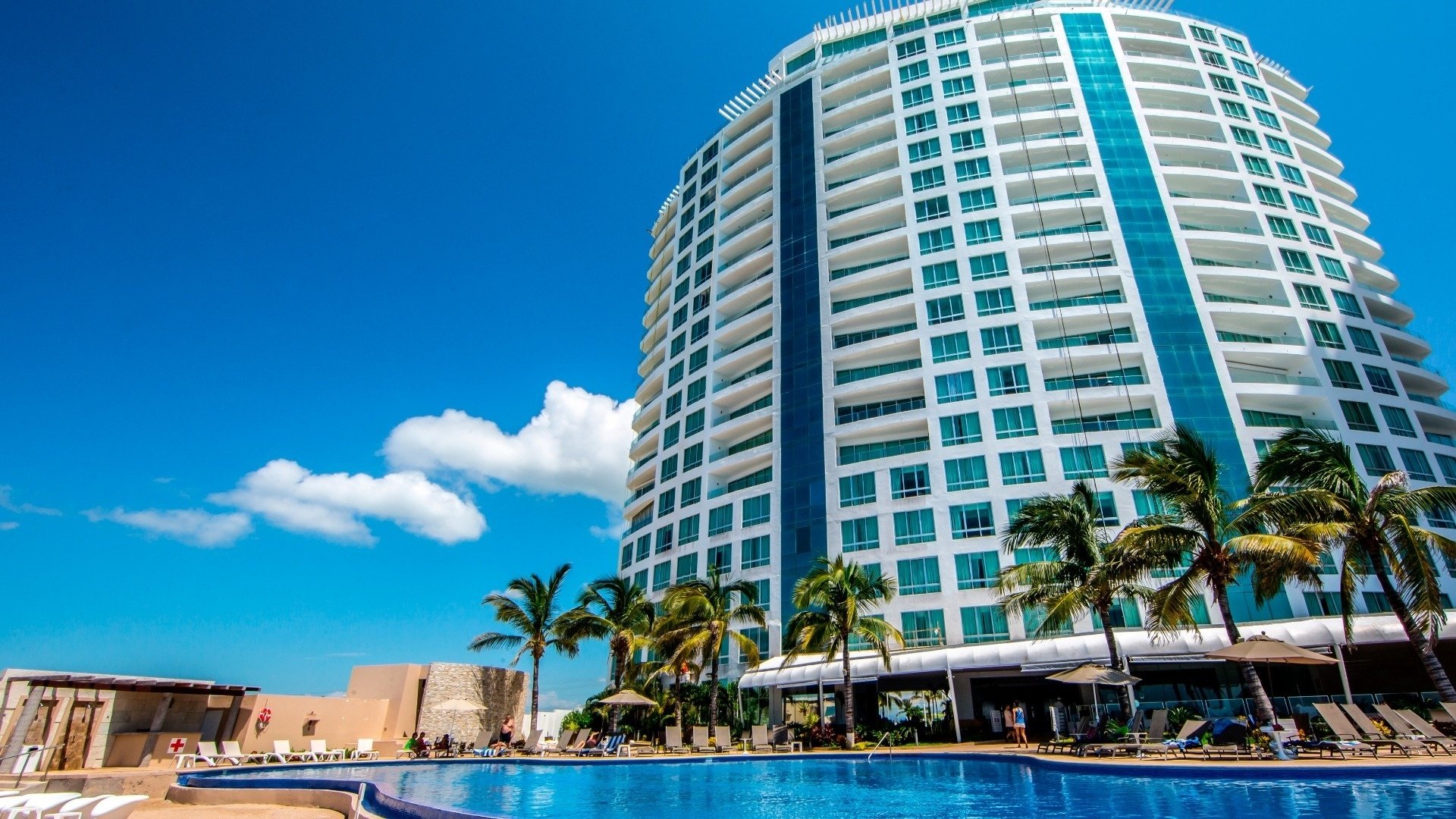 a large building with a swimming pool in front of it