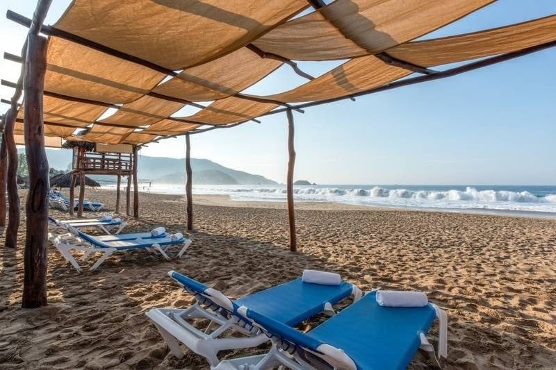 Hammocks under awnings by the sea in the resort Beach Ixtapa, Mexican Pacific