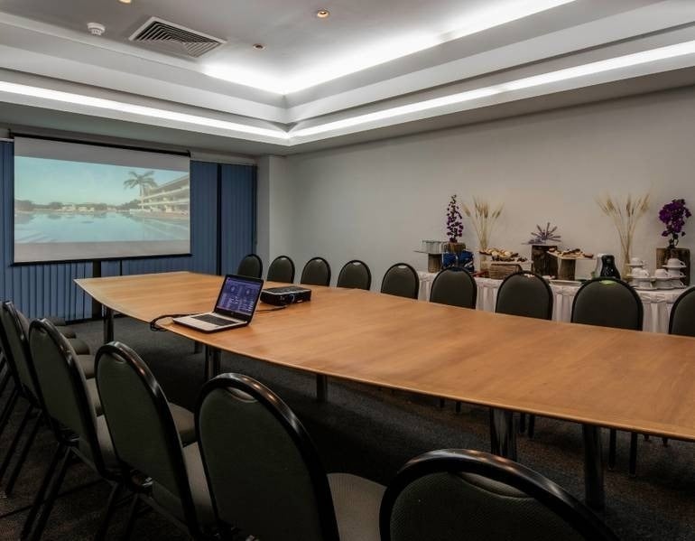 Park Royal hotels and resorts event room with table, chairs, computer and TV