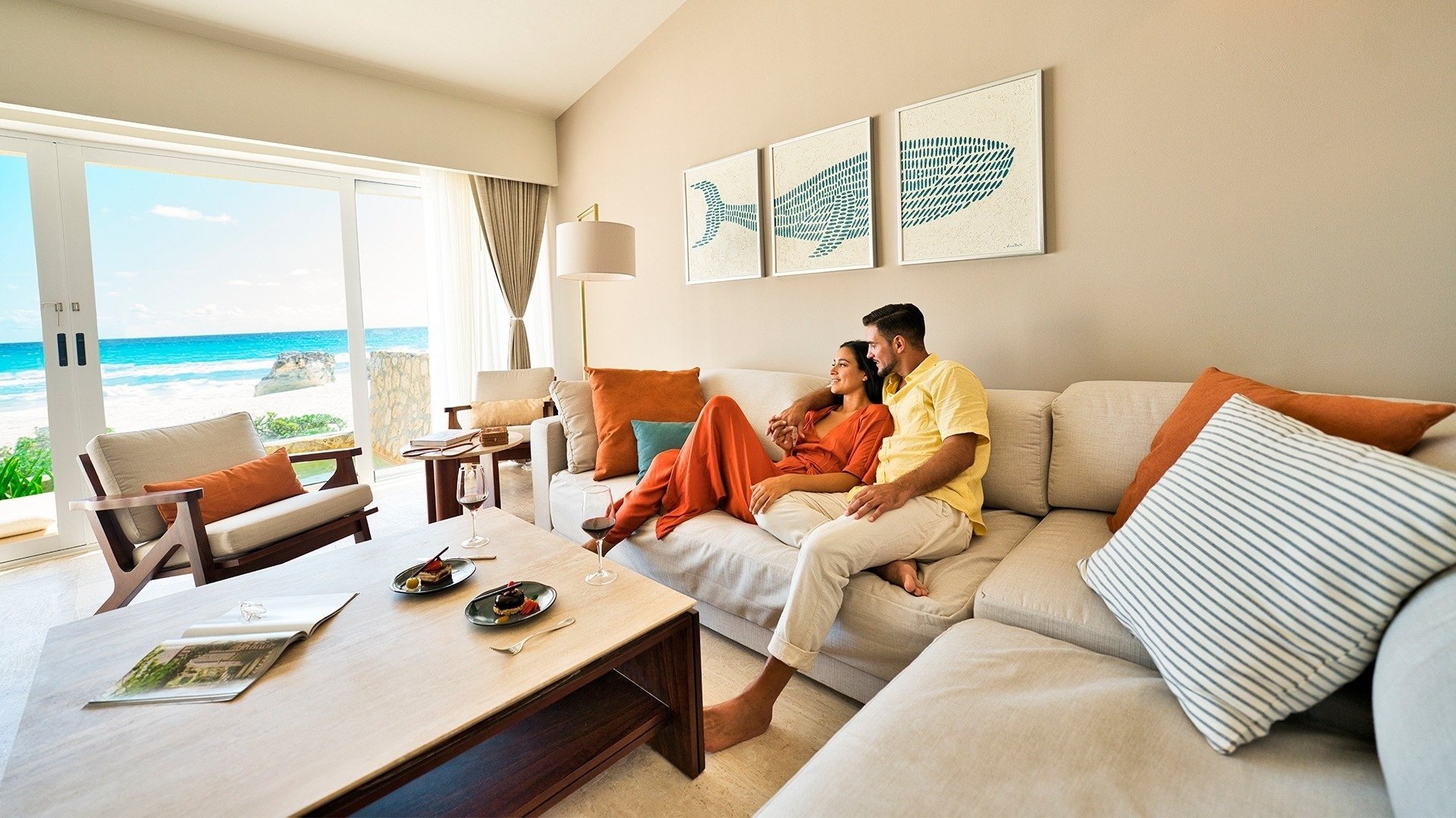 a man and woman sit on a couch in a living room