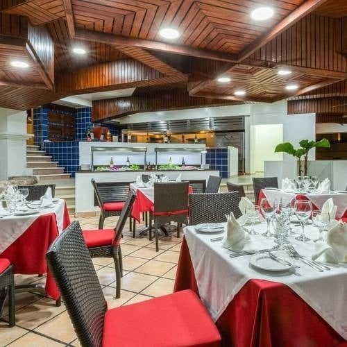 Restaurant with wooden ceiling making geometric shapes of the Hotel Park Royal Beach Huatulco