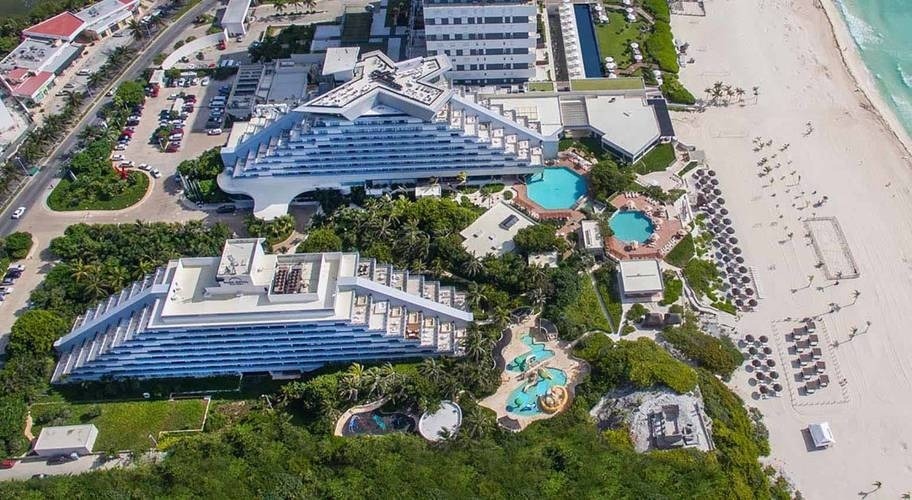 an aerial view of a resort with a pyramid shaped building