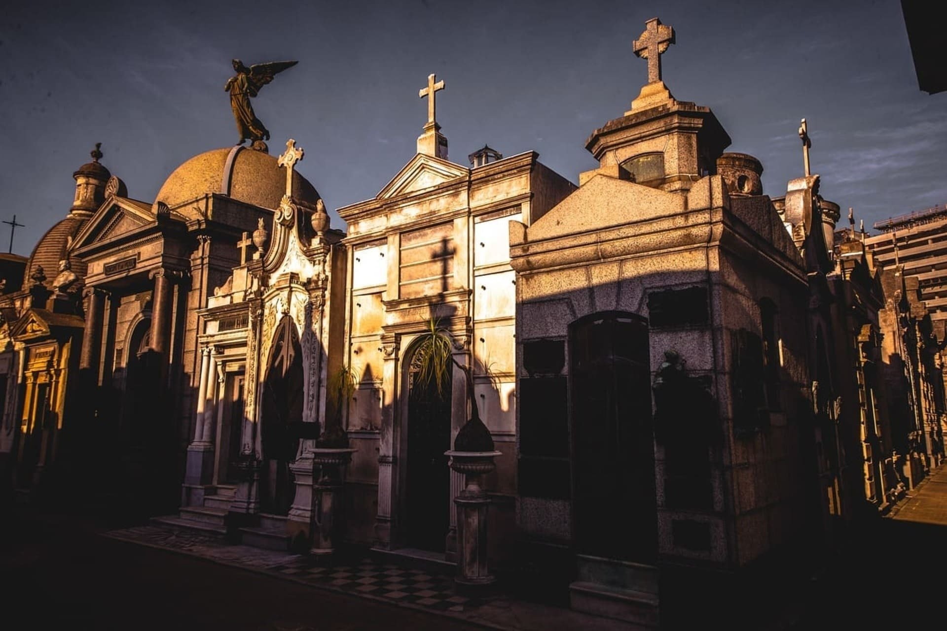 a cemetery with a cross on top of one of the buildings