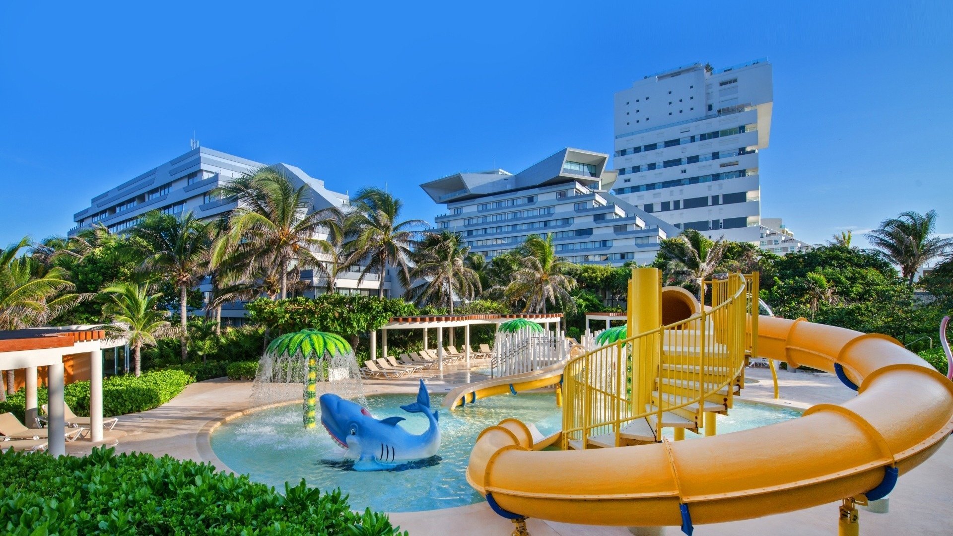 a children 's water park with a large building in the background