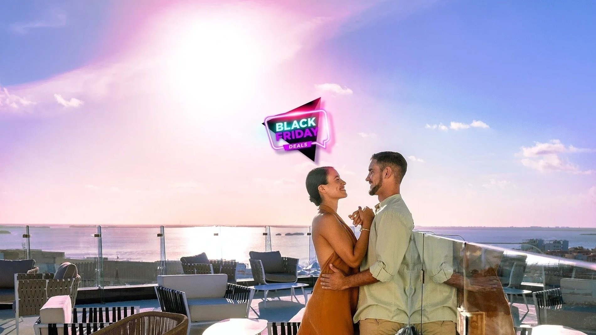 a couple standing on a balcony with a black friday sign above them